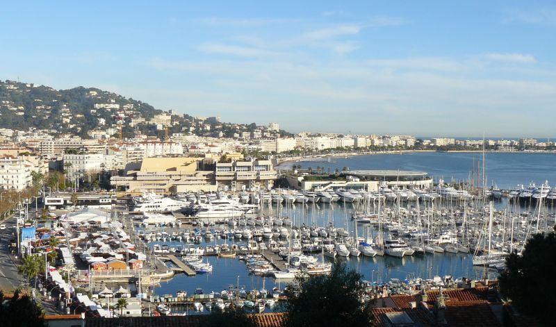 Sailboats and yachts in Cannes harbour, with the waterfront beyond